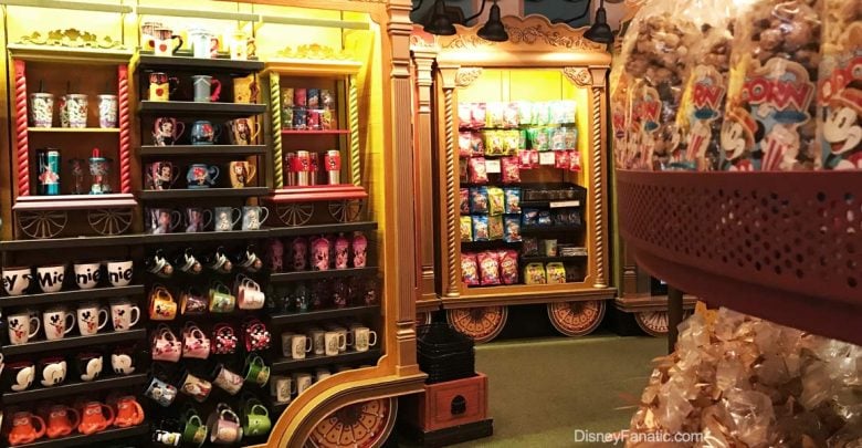 Disney Parks shelves display vibrant character mugs, sweet treats, and snacks inside a lively, immersive souvenir shop.
