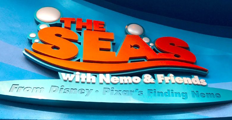 A colorful sign reads “The Seas with Nemo & Friends” with bubble graphics, above the text “From Disney·Pixar’s Finding Nemo,” on a blue background.