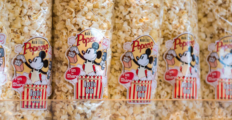 Kettle corn popcorn bags featuring a cheerful cartoon mouse and popcorn bucket, stacked neatly on a souvenir shop shelf.