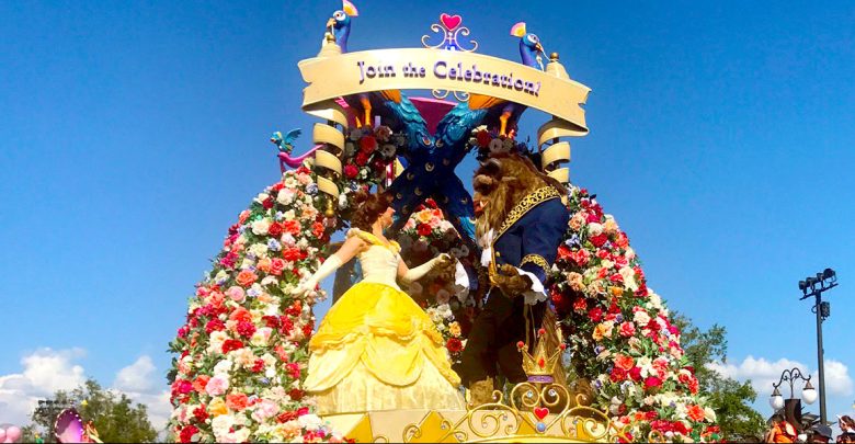 Belle and Beast waltz amid roses atop a colorful Disney World parade float, beneath a “Join the Celebration!” sign.