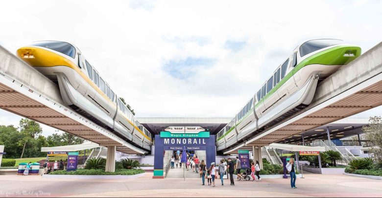 Monorail trains glide above crowds at the Magic Kingdom Monorail station, capturing that iconic Walt Disney World experience.