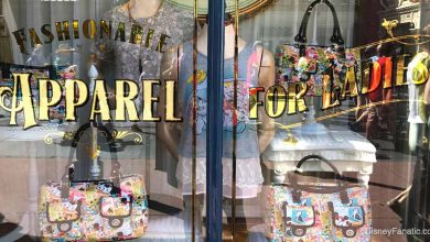 Vibrant storefront with playful bags and mannequins, marquee reads "Fashionable Apparel for Ladies" on Main Street, USA.