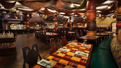 Bright Disney World eatery with lively fabrics, patterned tables, and wood chairs—top spot for a magical breakfast experience.