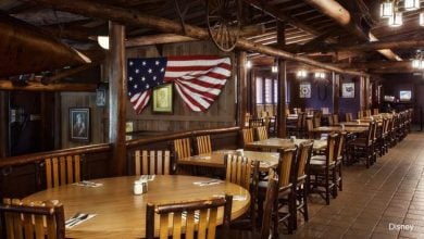 Cozy, Americana-themed dining room with wood furnishings and flag decor—ideal spot for a memorable Disney World breakfast experience.