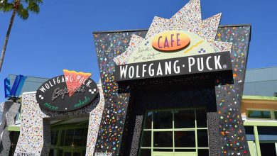 Wolfgang Puck Cafe’s vibrant mosaic façade and bold sign greet guests along Disney Springs’ lively entertainment promenade.