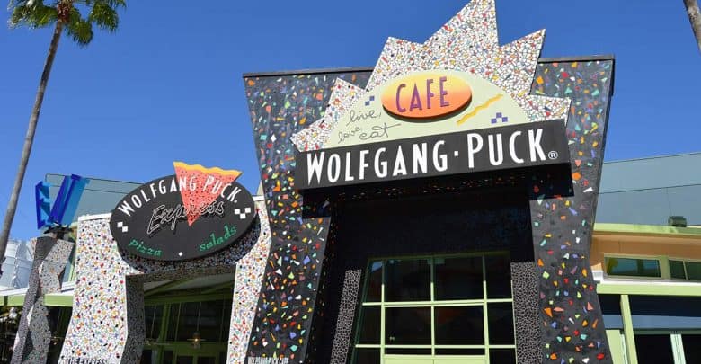 Wolfgang Puck Cafe’s vibrant mosaic façade and bold sign greet guests along Disney Springs’ lively entertainment promenade.
