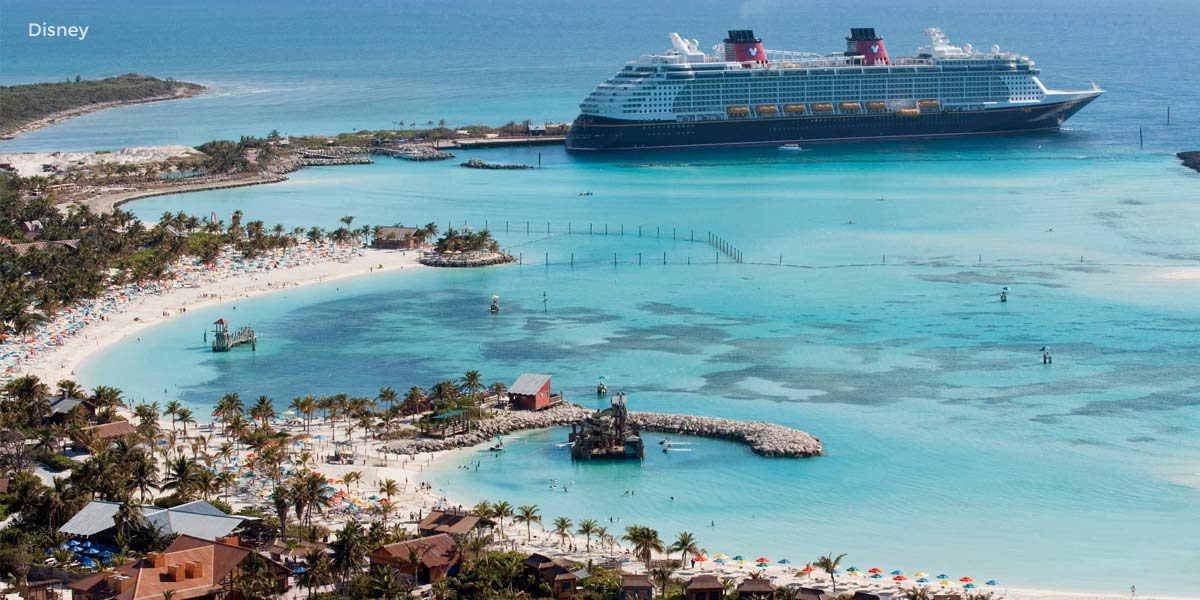 Cruise ship arriving at a tropical island vacation destination.