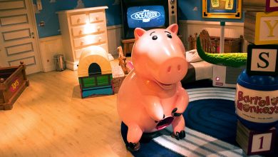 Hamm the piggy bank from Toy Story stands in Andy’s vibrant, toy-filled bedroom at Pixar Pier.