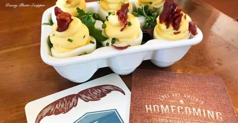 A festive tray of deviled eggs with bacon and chives, ready for your next big theme park party at a lively attractions table.