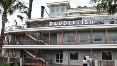 Paddlefish at Disney Springs with its bold sign, lively deck railings, and guests strolling along the waterfront entrance.