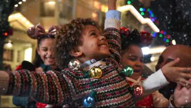 child on Main Street in the snow during Christmas party