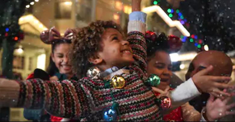 child on Main Street in the snow during Christmas party