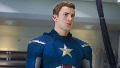 Captain America in his classic blue suit with a star emblem poses heroically inside an Avengers-themed attraction.