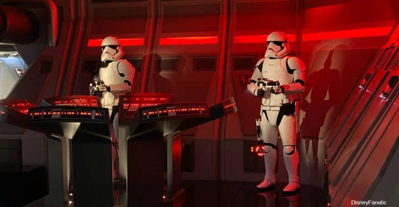 Stormtroopers monitor control panels in a glowing red Star Wars spaceship, ensuring galactic order like Disney Park security.