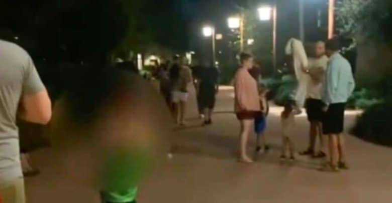 Guests standing outside on a pathway in the middle of the night after an emergency alarm at Disney's Animal Kingdom Lodge Villas - Jambo House.