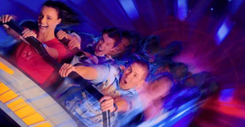 A man and a woman in a Disneyland ride vehicle - Space Mountain.