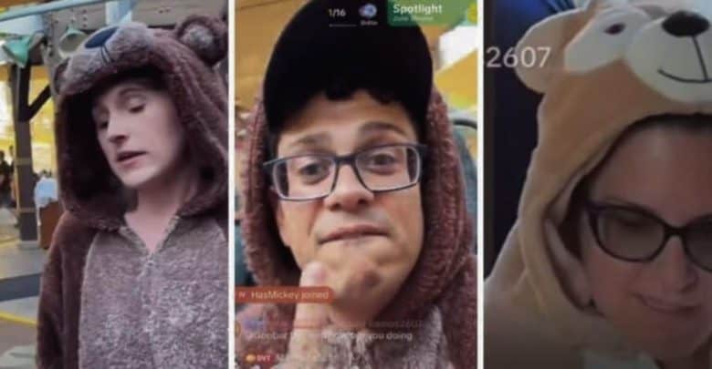 Three people wearing bear costumes at Disneyland Resort, violating the Disney dress code. One is putting up the middle finger.