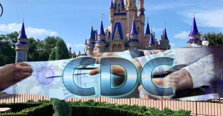 A digital collage shows the acronym "CDC" in large blue letters overlaying the image of a castle with purple spires. The background blends a photograph of a Disney World theme park castle with digital images of hands holding medical tools and charts.
