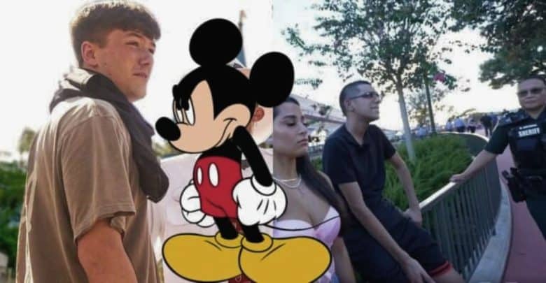 Image features a large cartoon Mickey Mouse in the center. On the left, a young man with short brown hair looks to the side. On the right, Disney influencers with short hair are seated on a railing next to another person in a white shirt and a standing sheriff.