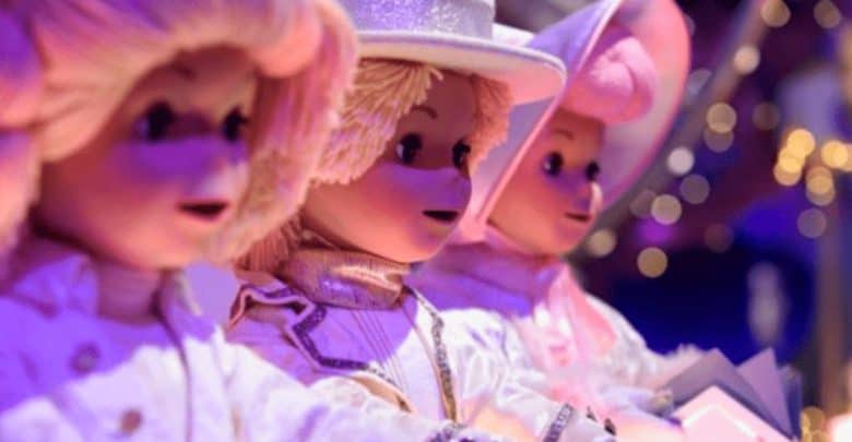 Three animatronic dolls on it's a small world.