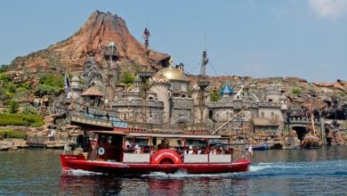A boat sails past Journey to the Center of the Earth at Tokyo DisneySea