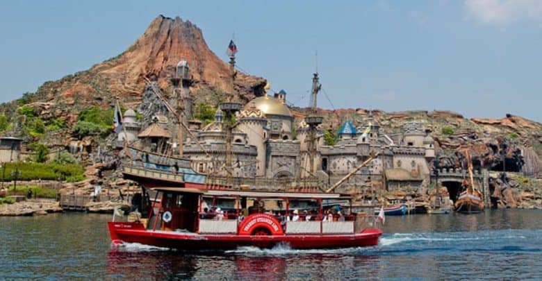 A boat sails past Journey to the Center of the Earth at Tokyo DisneySea