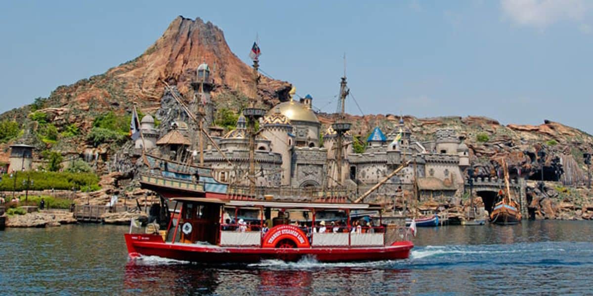 A boat sails past Journey to the Center of the Earth at Tokyo DisneySea