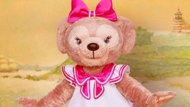 ShellieMay wearing a dress and pink bow