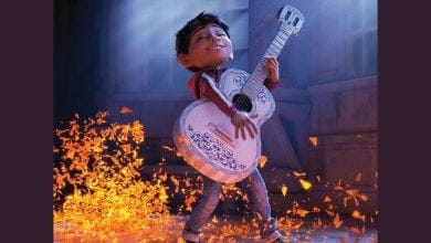 A cartoon character holding a guitar.