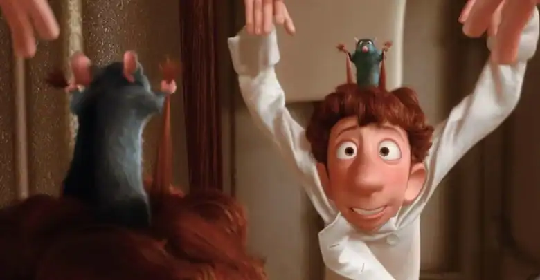 A cartoon chef with messy brown hair raises his arms while a small gray rat stands on his head, copying the gesture. Another rat sits on the head of a person in the foreground.