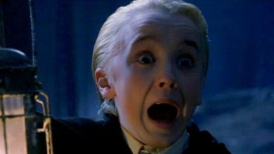 A young boy with slicked-back blond hair screams in fear while holding a lantern in a dark, eerie setting. His eyes are wide, and his mouth is open in shock.