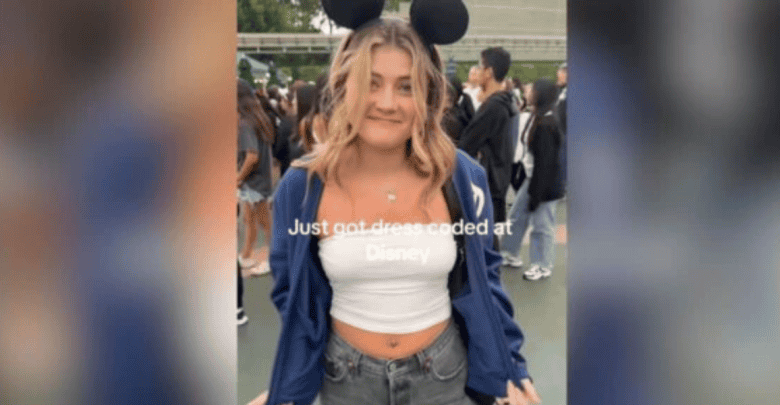 A young woman wearing Mickey Mouse ears and a white tube top that violated the Disney dress code.