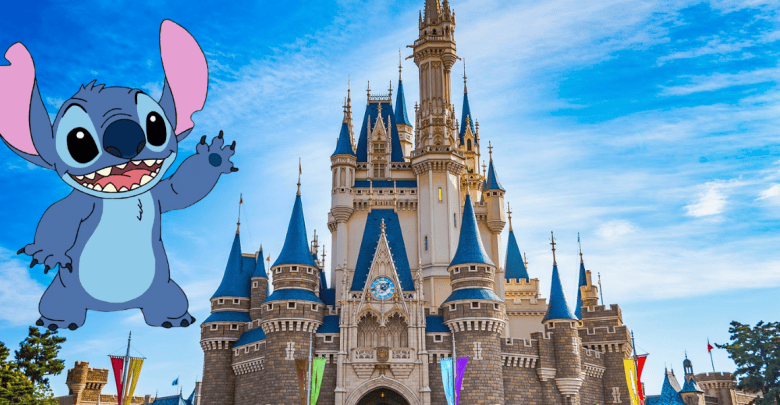 Cartoon character Stitch waves in front of a large Disney-style castle with blue spires, under a bright blue sky with some clouds. Colorful banners hang on the castle.
