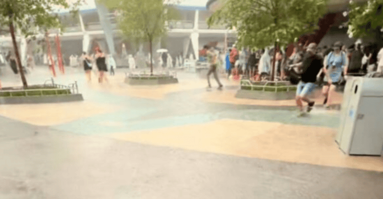 People walking through a flooded Tomorrowland in Magic Kingdom
