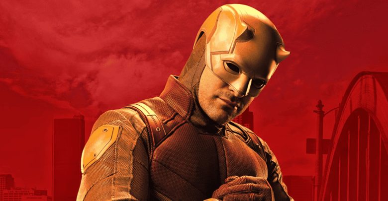 A person in a yellow superhero costume and helmet stands with their hands clasped, against a red background with part of a cityscape and a bridge visible.