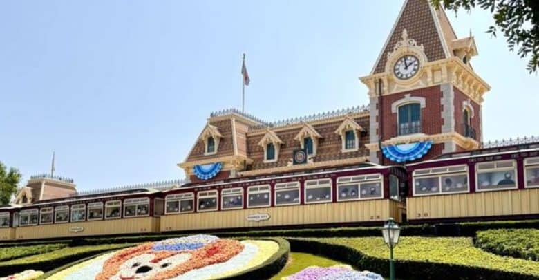 The Disneyland Train Station’s clock tower, bunting, and floral Mickey face—an iconic welcome for Disney Annual Passholders.