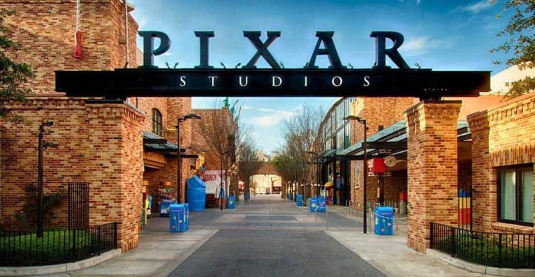 Pixar Studios’ iconic entrance gate and brick buildings shine under sunny skies, teasing fans for the June 2027 movie launch.