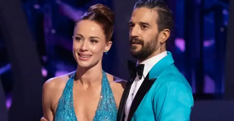 A glamorous woman in a sparkly blue dress poses with a man in a turquoise suit at Disney Studios, bringing DWTS flair to the park.