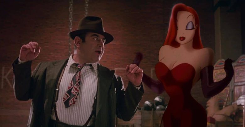 A guest in a suit reacts with surprise beside Jessica Rabbit posing in her signature red dress and gloves at a Disney park.