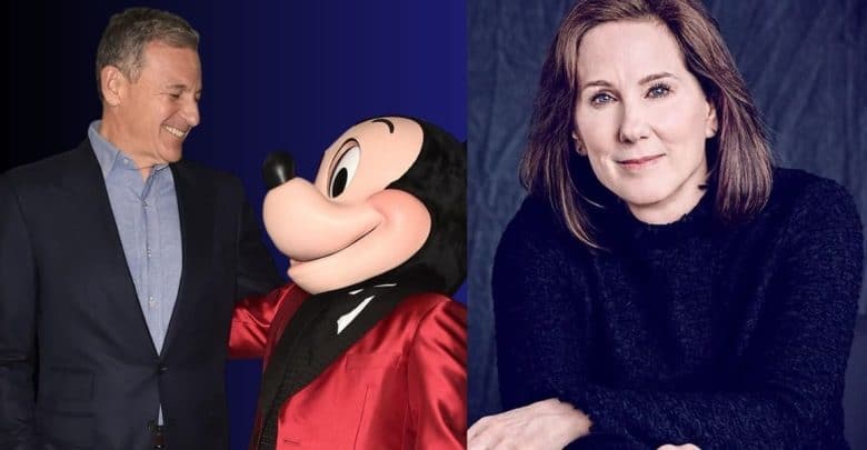 A happy guest smiles at Mickey Mouse in a dapper red tux, while a woman with light brown hair sits nearby, looking at the camera.