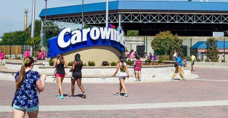 Guests stroll past the iconic Carowinds entrance sign