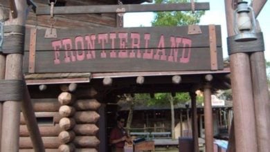 A wooden sign reading "FRONTIERLAND" at the Magic Kingdom.