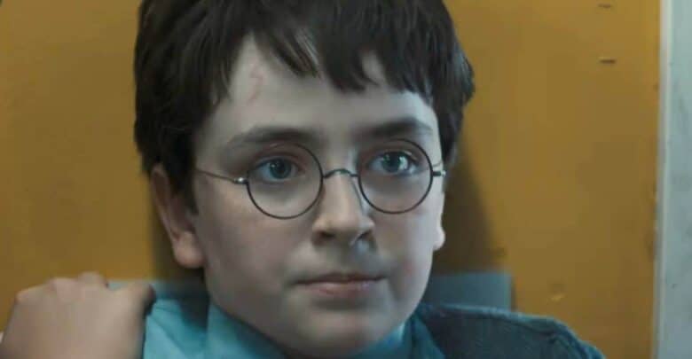 Harry Potter, in signature glasses and dark hair, sits calmly by a yellow wall—evoking the magic of HBO’s new Wizarding World.