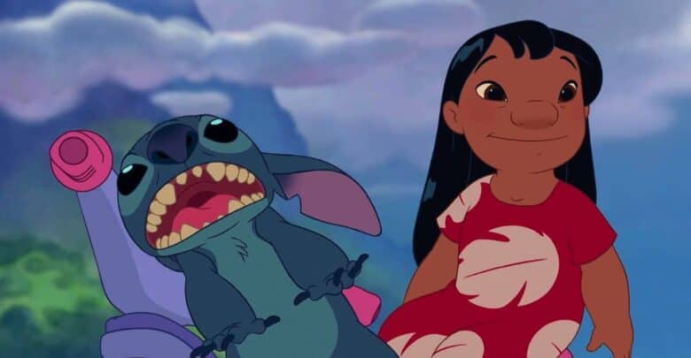 Lilo in her signature red dress stands with Stitch, mouth open in excitement, under the night sky at a Disney park.