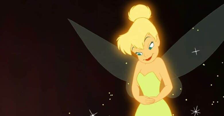 Tinker Bell glows amid sparkling lights, her green dress and wings shining against a magical nighttime backdrop.