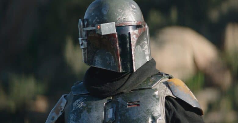 The Mandalorian, clad in weathered armor and helmet, greets fans amid the immersive Star Wars setting at the theme park.