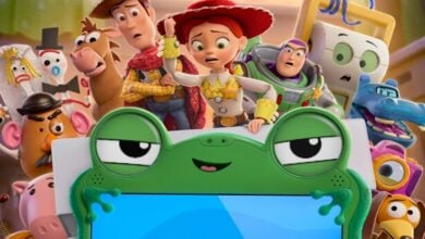 Woody, Jessie, and Buzz Lightyear pose with fans behind a green frog easel at Pixar Pier, celebrating their movie’s release.