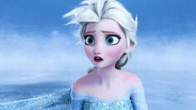 Elsa, with her signature pale skin and white hair, appears surprised as she stands in a frosty, snow-covered Arendelle—an eye-catching moment that’s sure to capture the attention of Disney Parks visitors debating the latest Frozen casting news.