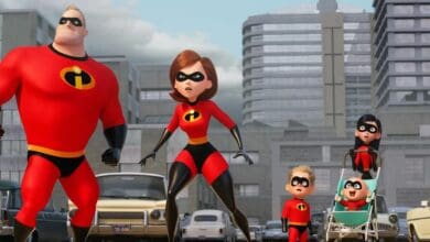 The Incredibles, dressed in their iconic red suits, stand poised for action on a vibrant city street—an energetic tableau that captures the thrilling spirit guests love at Pixar-themed lands and leaves everyone buzzing about the possibility of Incredibles 3 coming to life in parks and beyond.