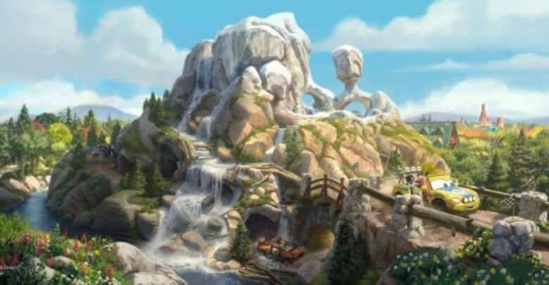 Radiator Springs Racers zoom along the track, winding past majestic rocky mountains with cascading waterfalls, lush trees, and a bright blue sky inside Cars Land at Disney California Adventure.